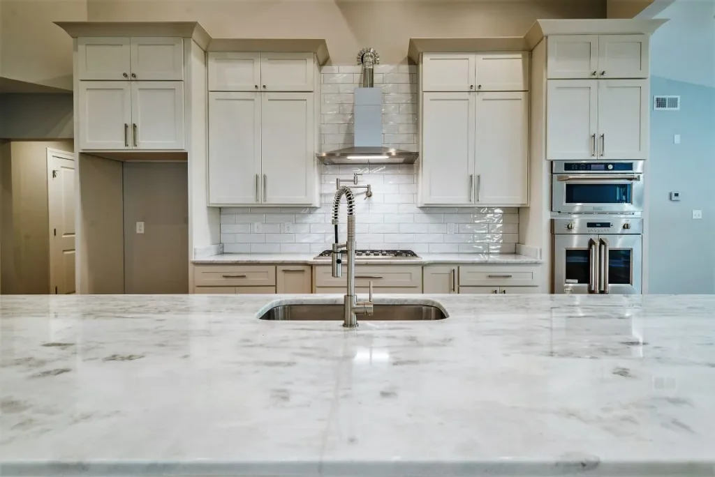 Kitchen Renovations 2 Kitchen with granite counters and crown molding at the top of cabinets.