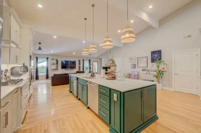 Kitchen Renovations 8 Open space kitchen remodel with green and white custom cabinets and granite counter.